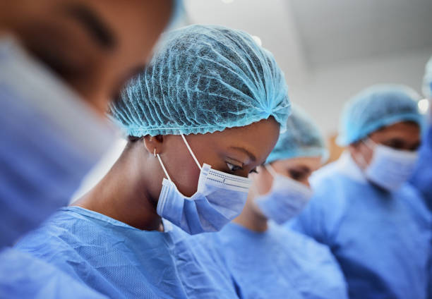 Surgical team in scrubs during a procedure in the operating theatre